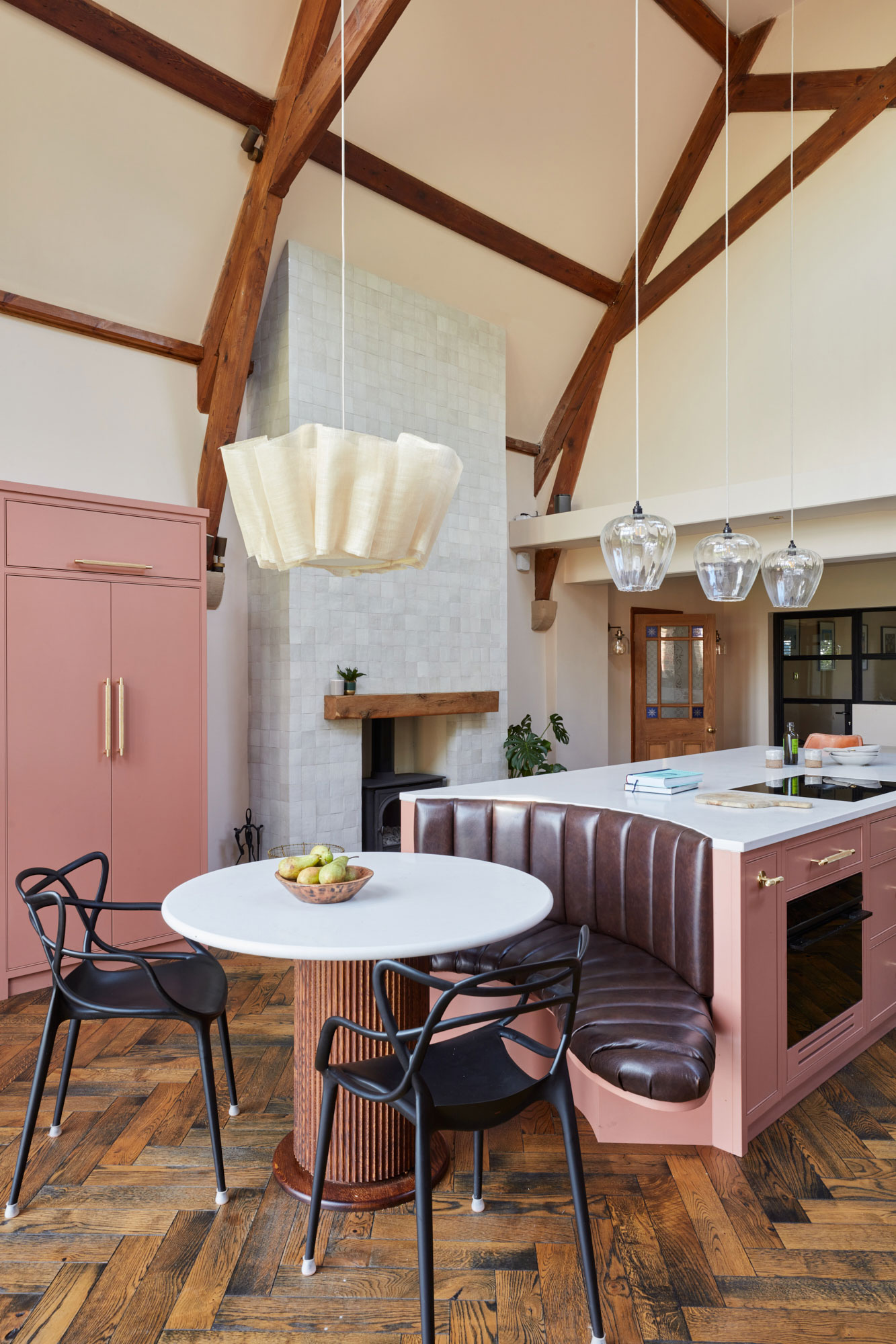Round kitchen table integrated in to bespoke pink island