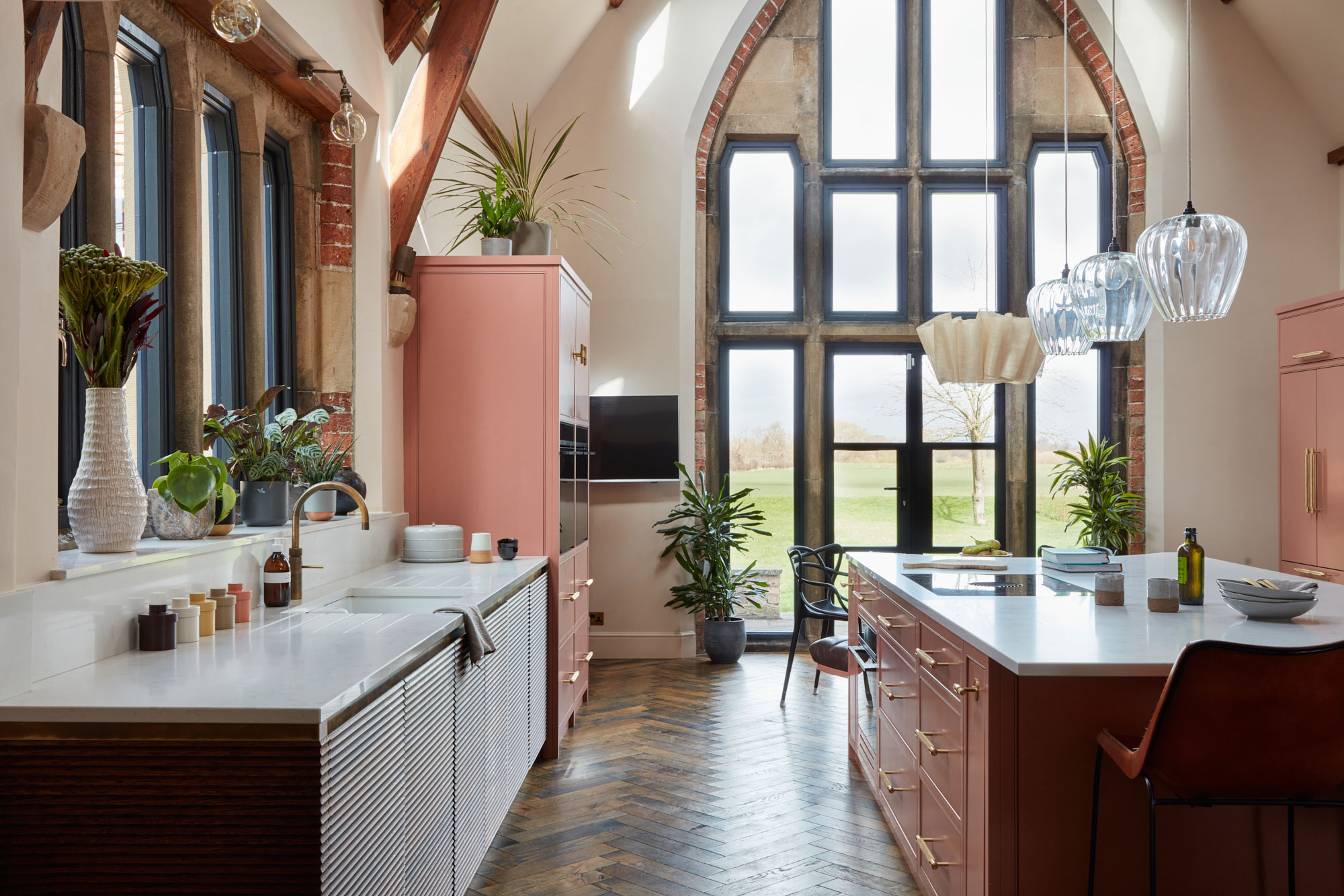 Large open plan pink kitchen design by The Main Company