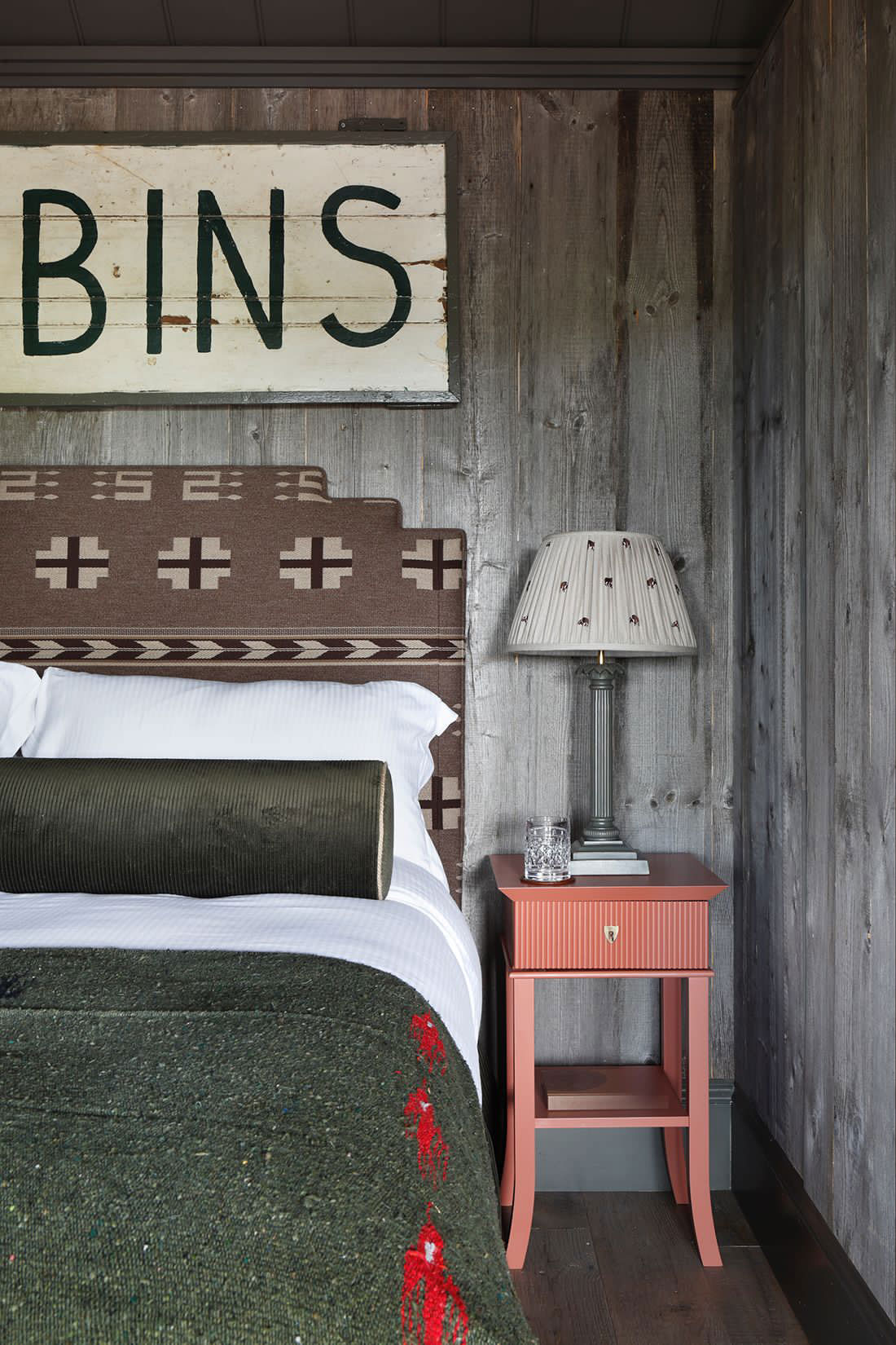 Cozy bed in rustic wood cabin