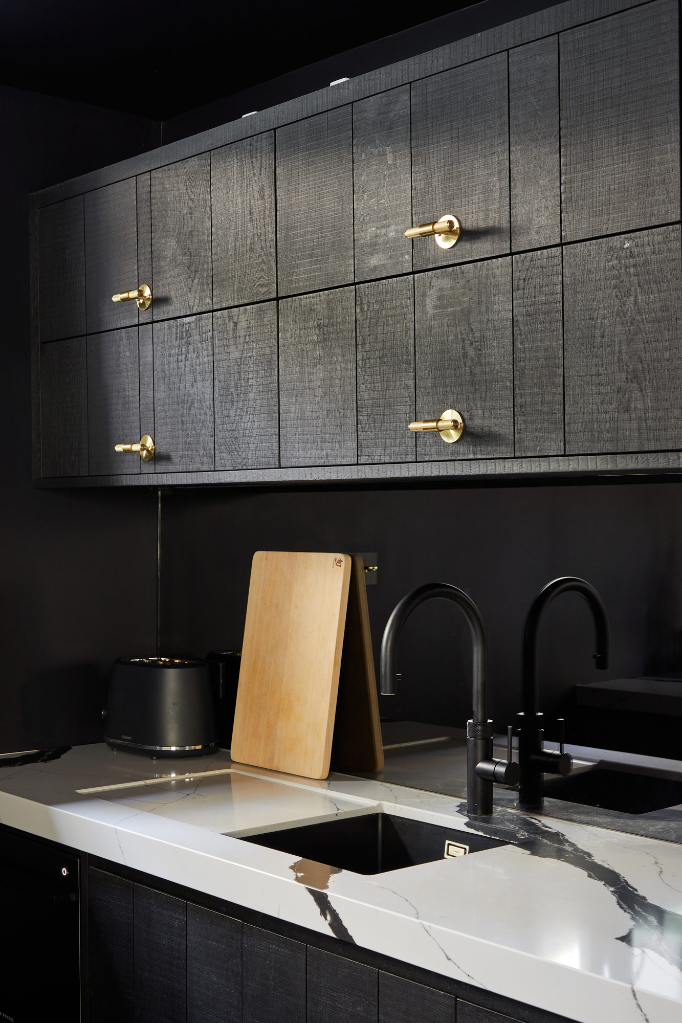 Bespoke black oak kitchen cabinets above sink