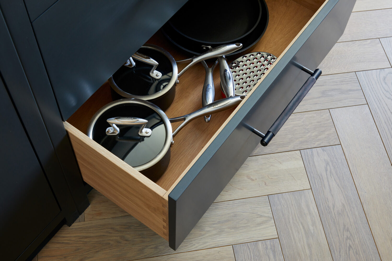 cookware kept in bottom draw of the kitchen 