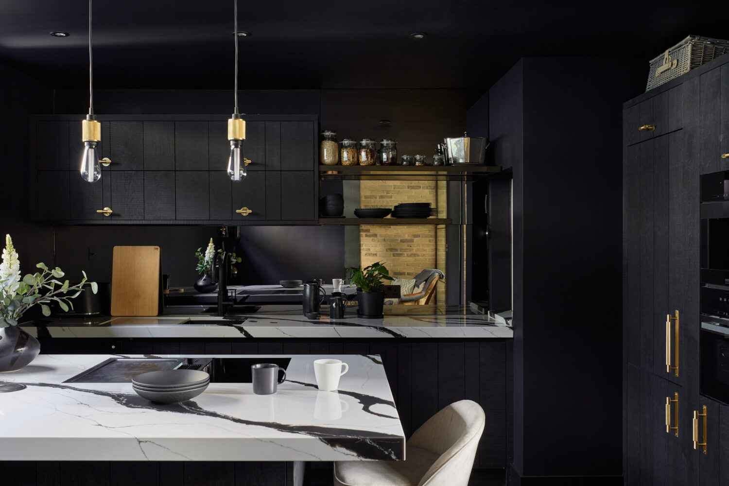 dark coloured kitchen with a mirror backsplash