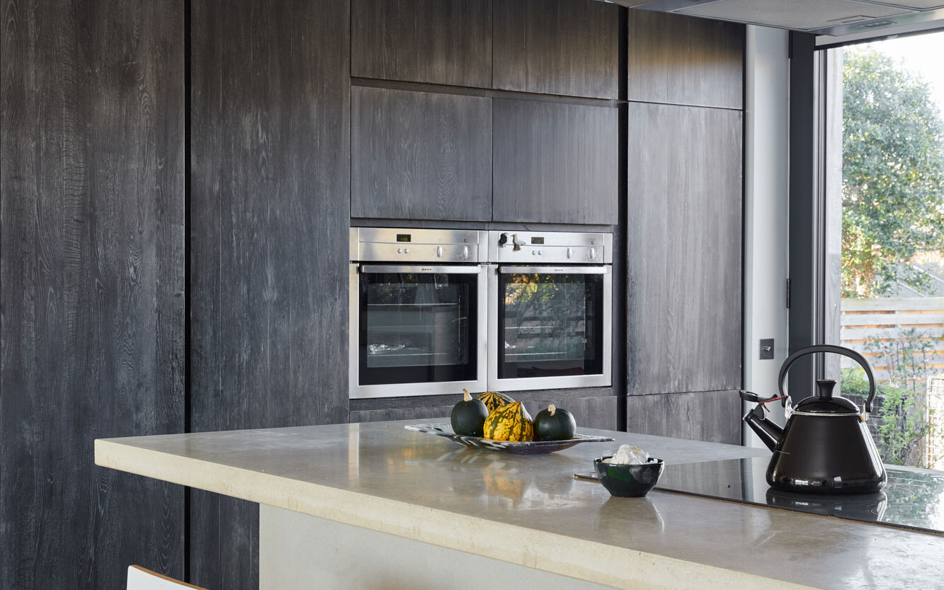 Kitchen with dark cabinets and concrete island