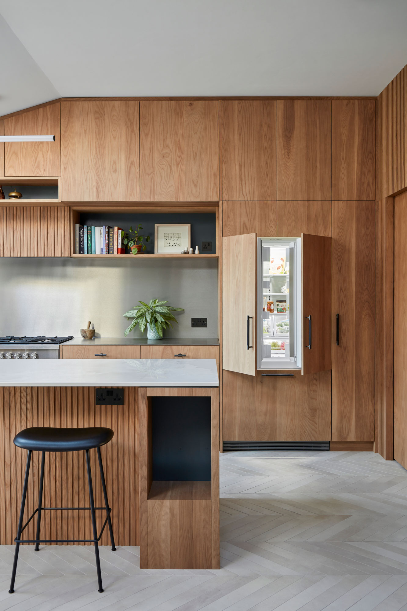 Integrated fisher and paykel american fridge freezer in bespoke oak kitchen