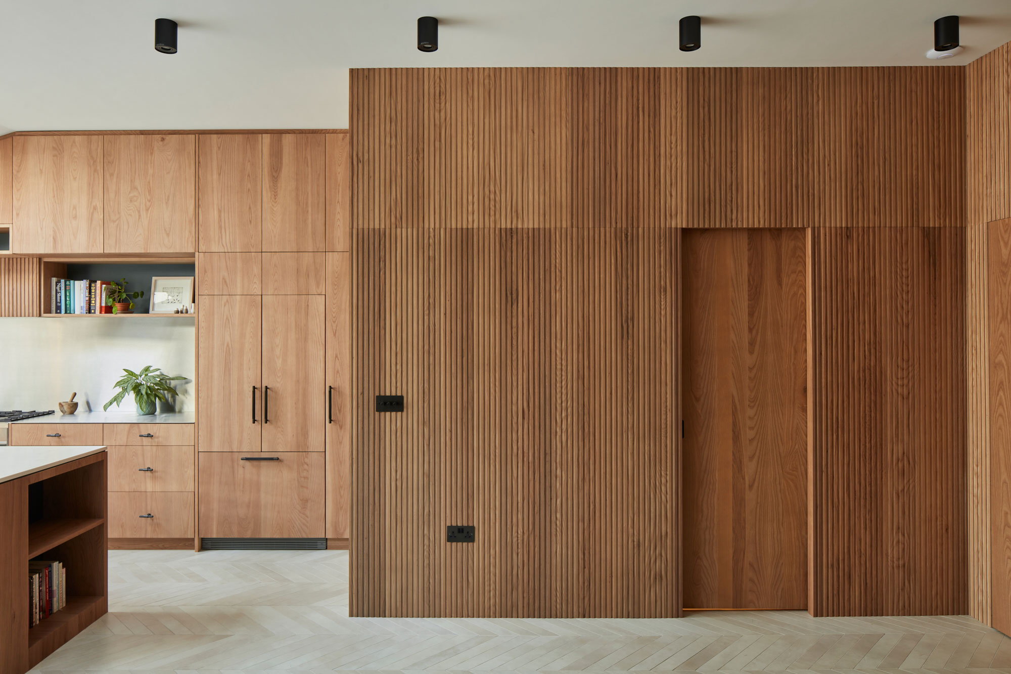 Fluted ash wall panels in bespoke kitchen