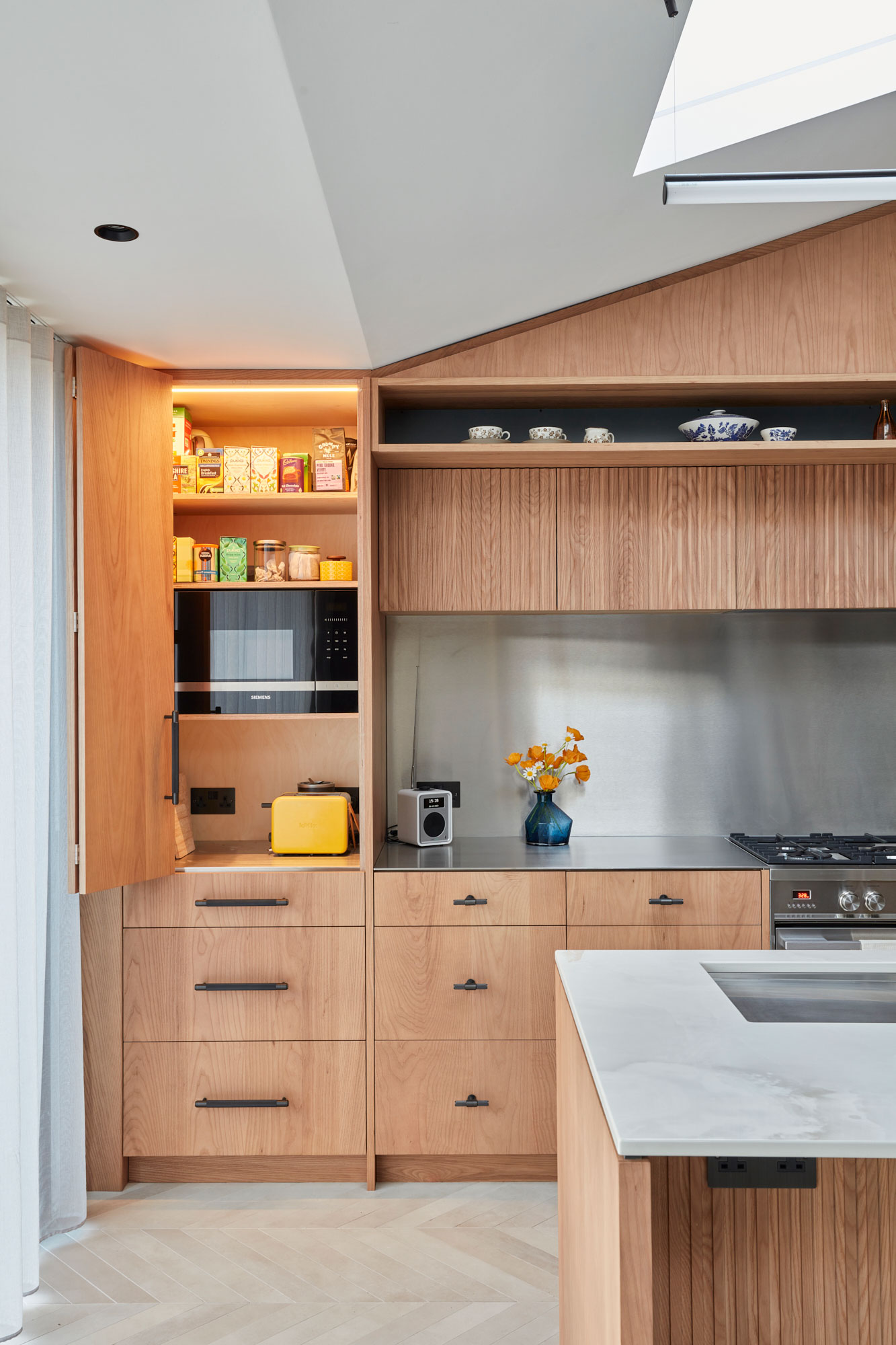 Integrated microwave in tall kitchen cabinet