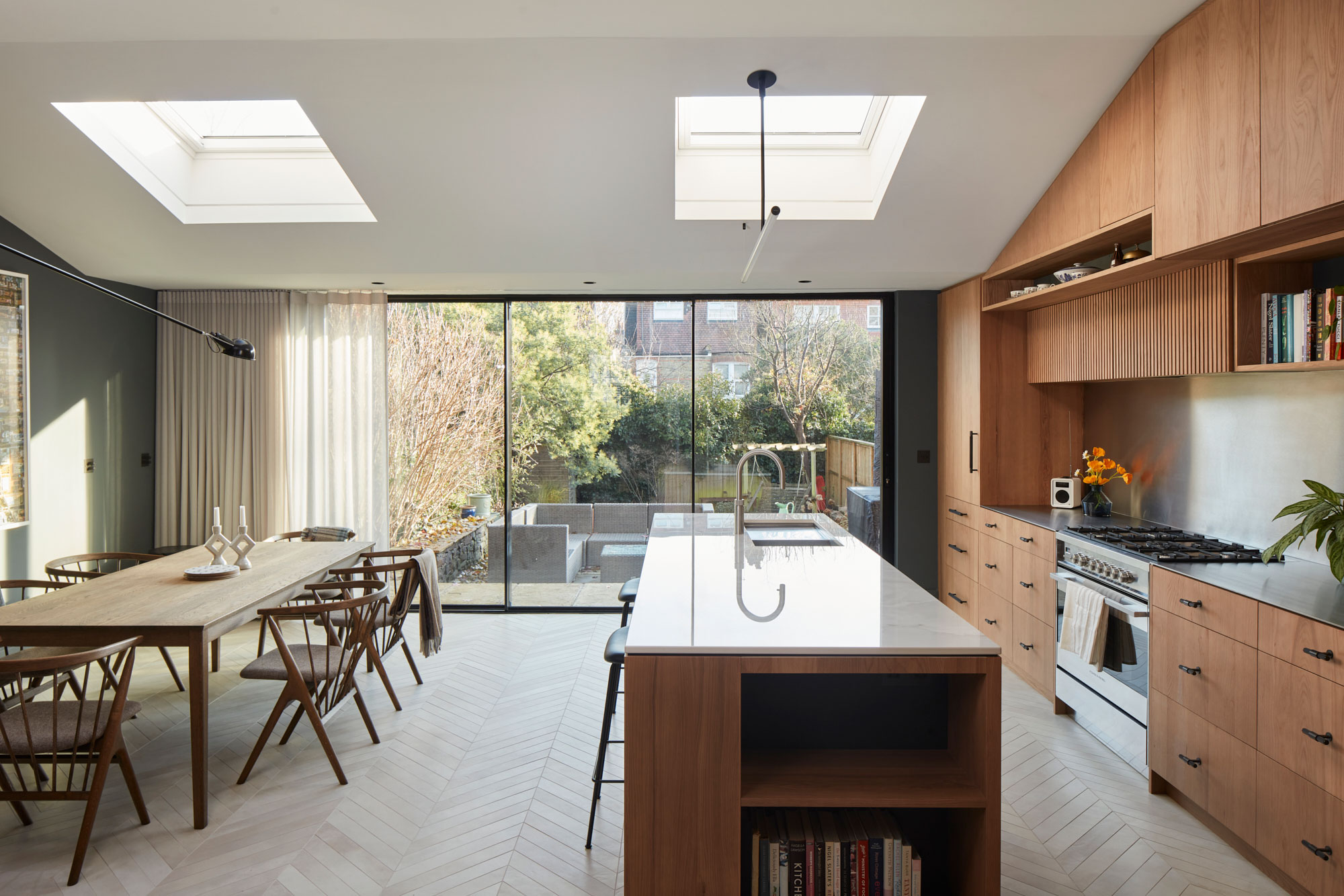 Open plan kitchen with book storage in large island