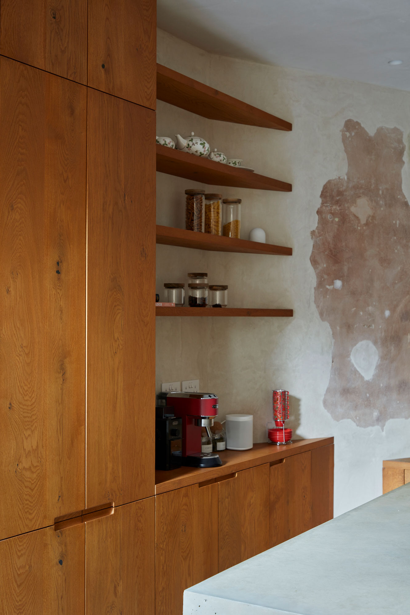 Simple floating oak kitchen shelves at coffee station